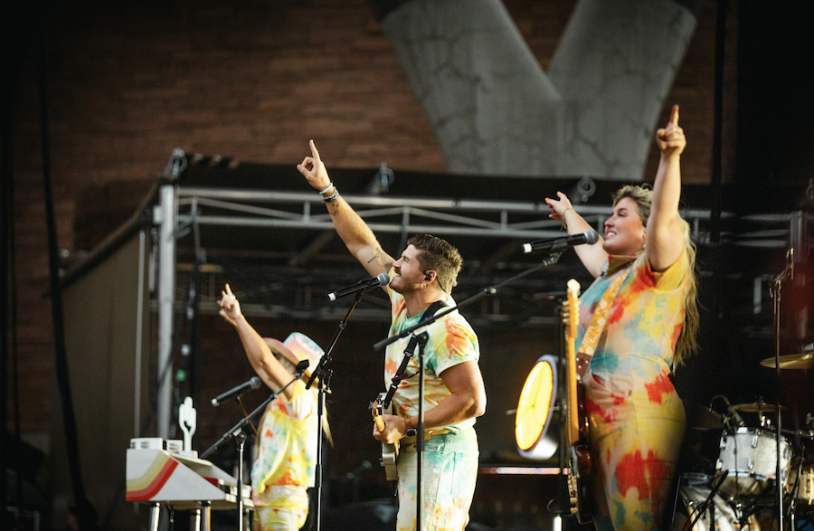 Band singing with their hands in the air